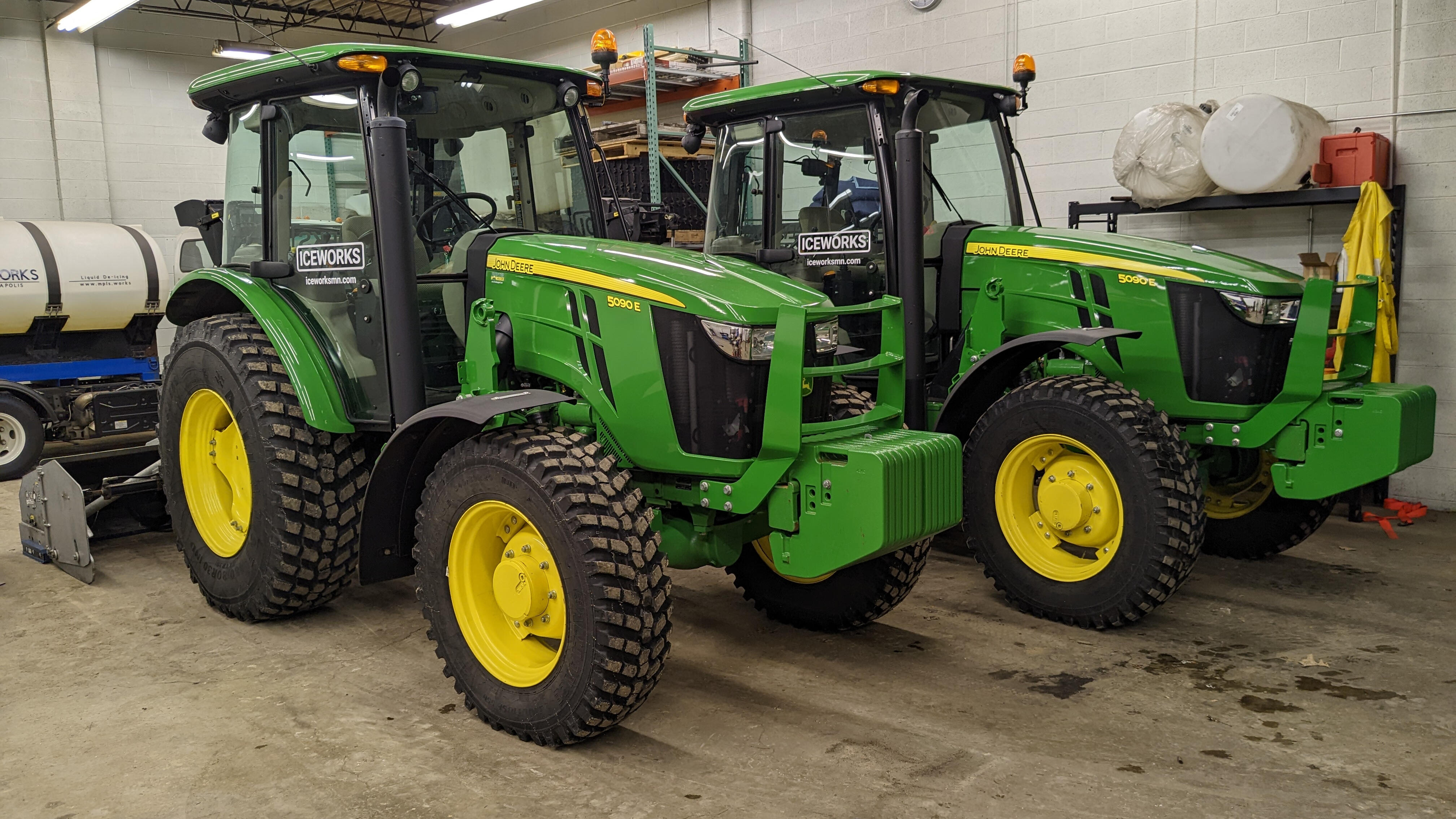 Iceworks tractor fleet with inverted snowblowers ready for residential snow removal in Blaine, MN